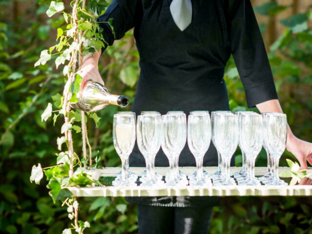 Waiter pouring champagne