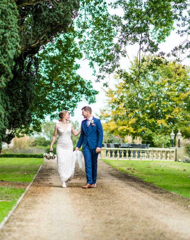 Bride & groom strolling in the garden